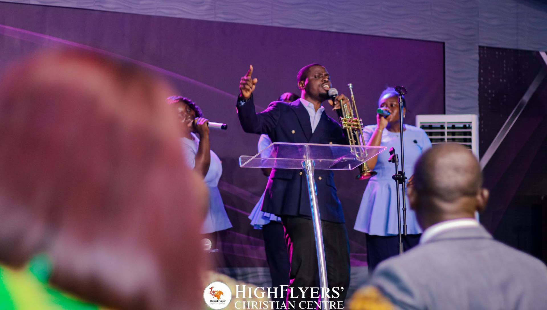 Worship leader ministering on stage at Highflyers Christian Centre